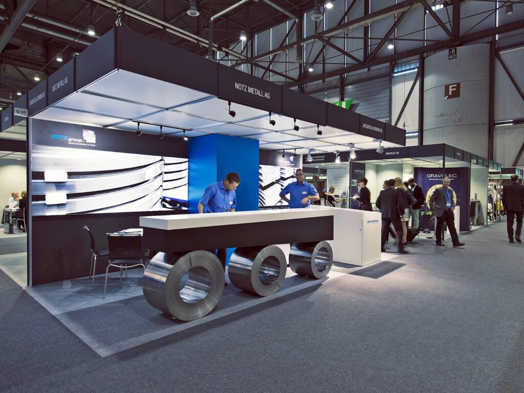 Exhibition booth with modern design and interactive displays, attracting visitors.