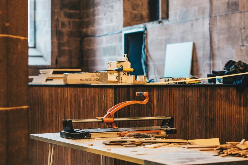 Woodworking tools and materials on a table in a workshop.