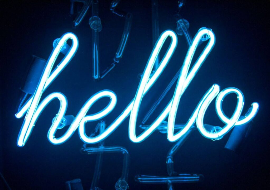 Neon sign displaying the word "hello" in blue light.
