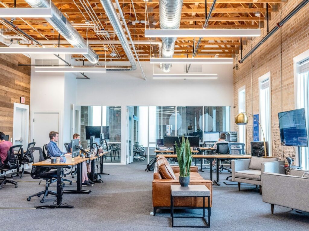Modern office with open layout, exposed ceilings, and collaborative workspaces.