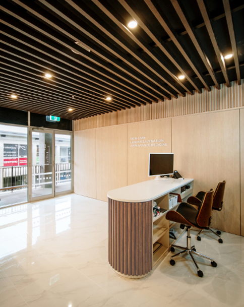 Modern office reception with wooden accents and sleek design.
